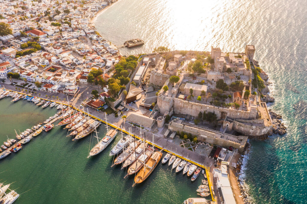 Bodrum Castle perches atop a craggy peninsula while modern-day yachts line its connecting harbor.