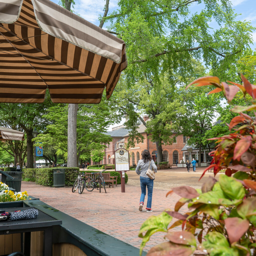 Female Student Walking Across A Campus Square In The Spring